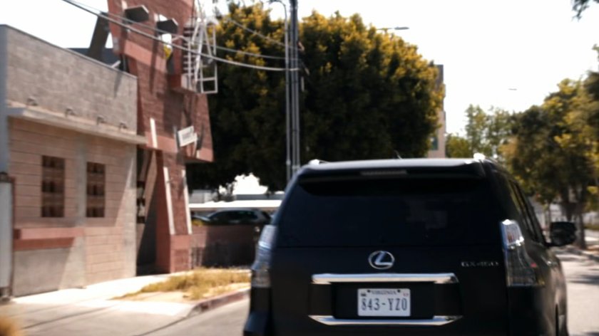 Coulson driving a SHIELD SUV along a city street.