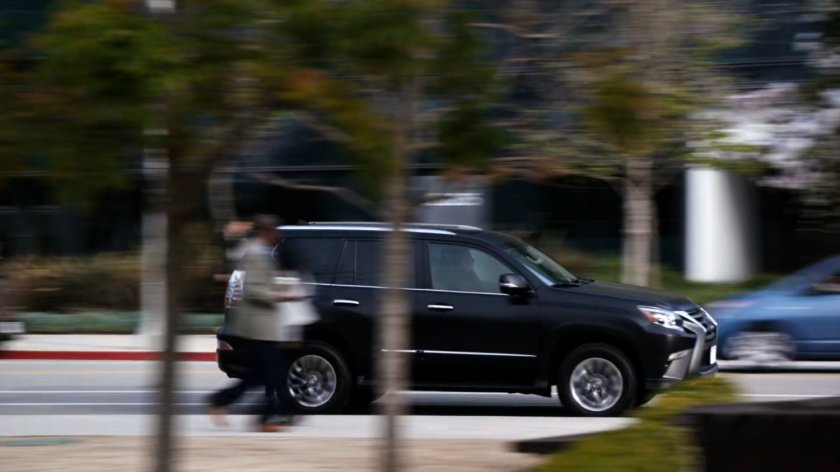 SHIELD SUV racing along city street.