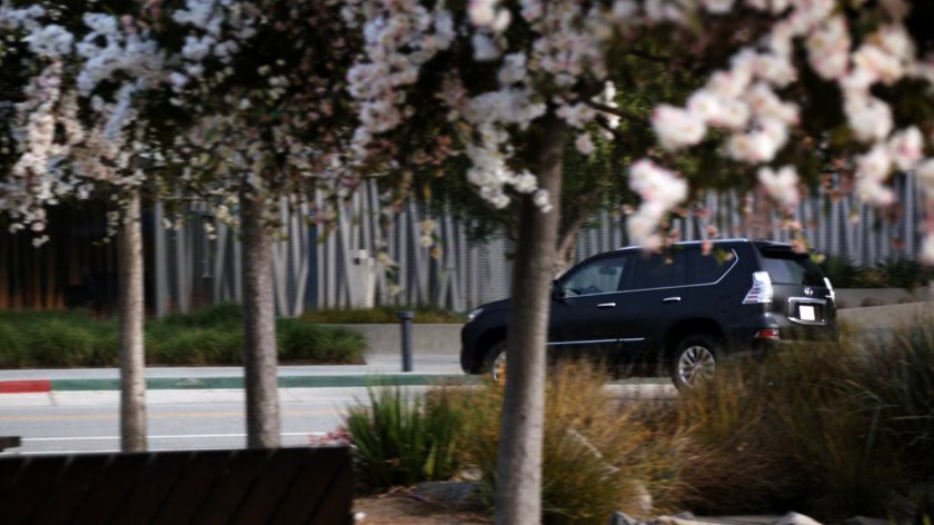 SHIELD SUV making u-turn along city street.