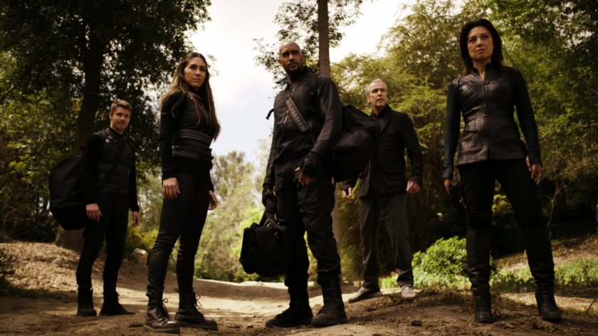 SHIELD agents stand in clearing on Pacific island.