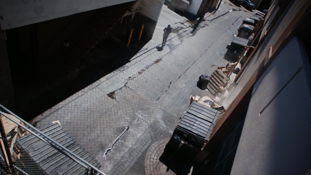 Daisy walks into alley.