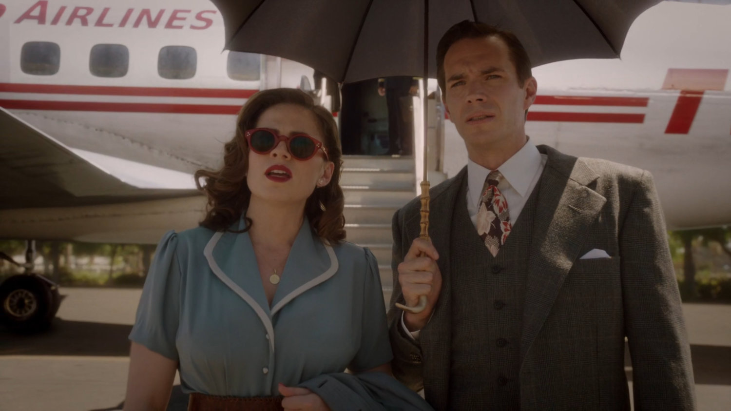 Peggy and Jarvis in front of TWA airplane at a Los Angeles airport.