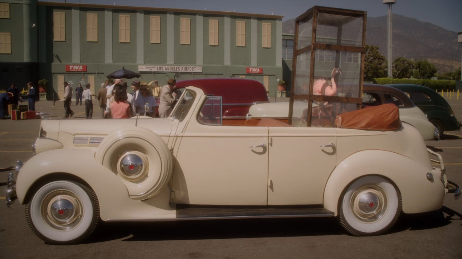Jarvis' car at a Los Angeles airport with a flamingo in the back seat.