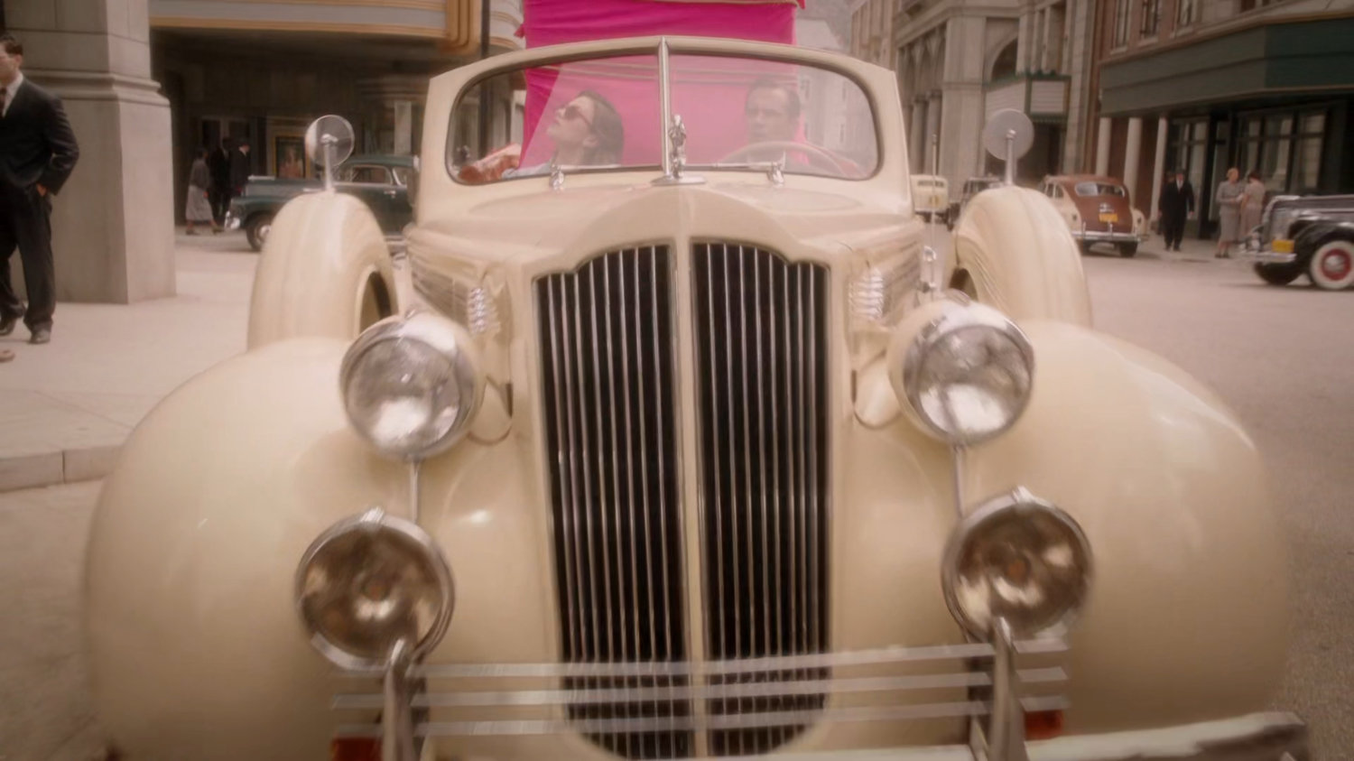 Peggy and Jarvis in car in front of the Auerbach Theatrical Agency
