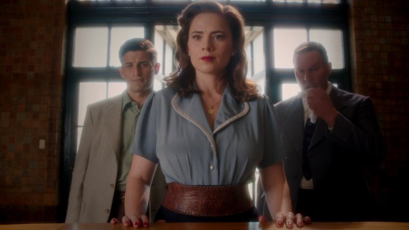 Sousa, Peggy, and Detective Henry in the Isodyne Energy lobby.