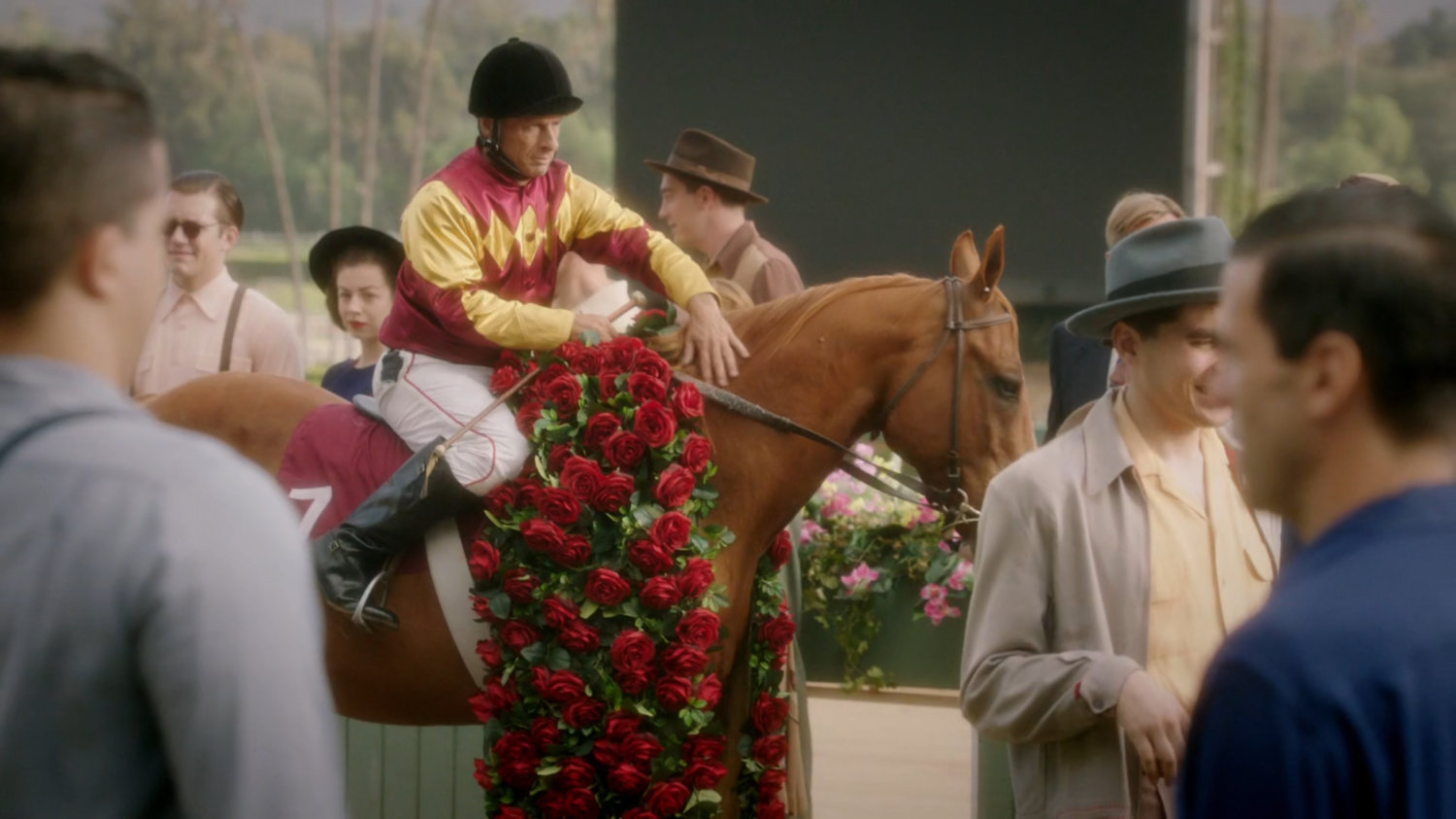 A jockey on a house with crowd at Santa Anita racetrack.