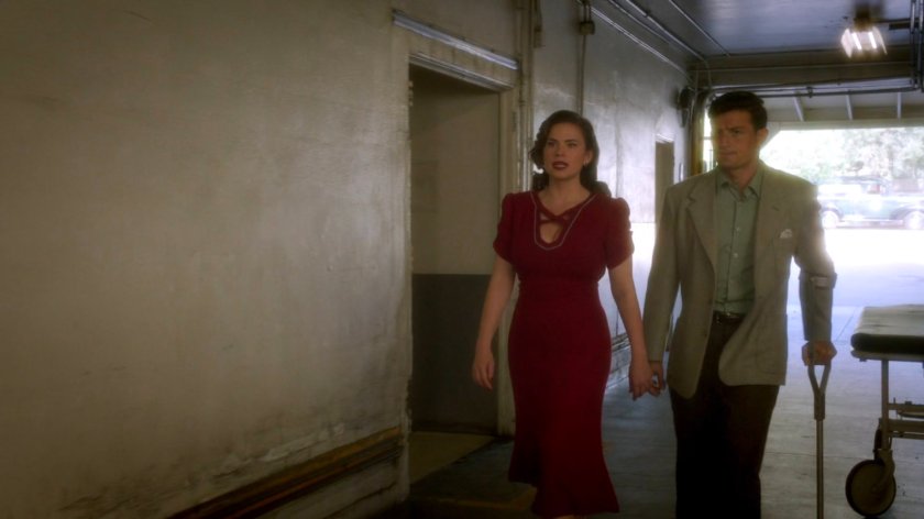 Peggy and Sousa entering the back entrance of the coroner office.