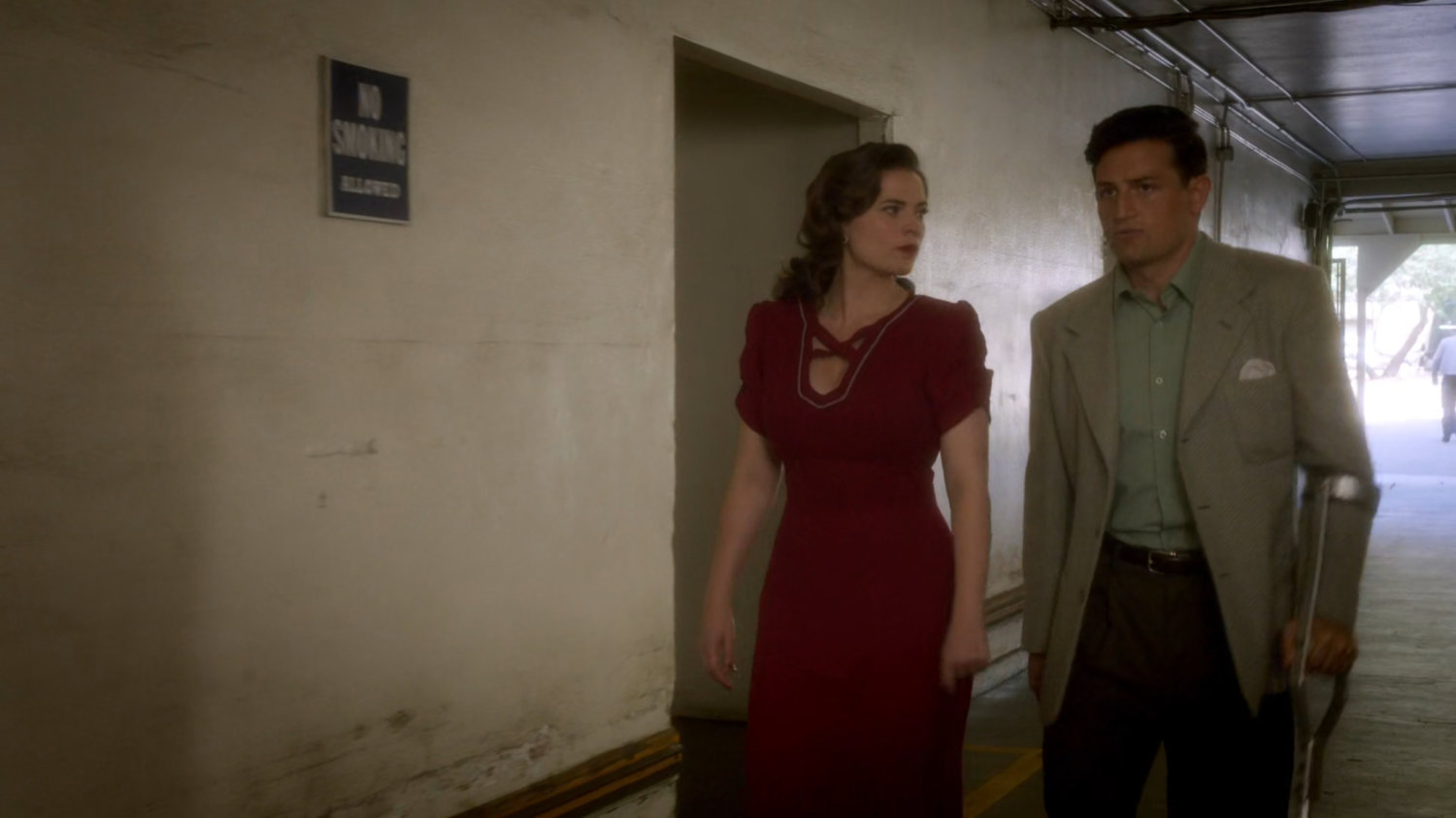Peggy and Sousa entering the back entrance of the coroner office.