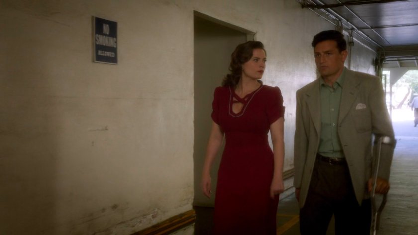 Peggy and Sousa entering the back entrance of the coroner office.