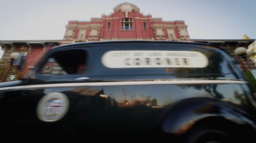 Coroner van in front of coroner office.
