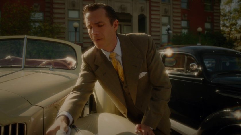 Jarvis tending his car in front of the coroner's office.