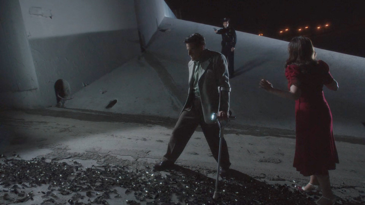 Sousa and Peggy standing over shattered remains of Detective Henry.