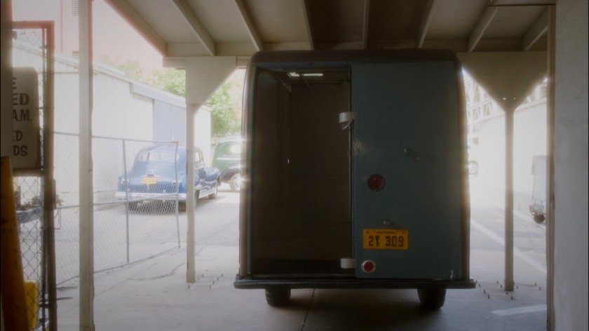 Van sitting at back entrance to coroner's office.