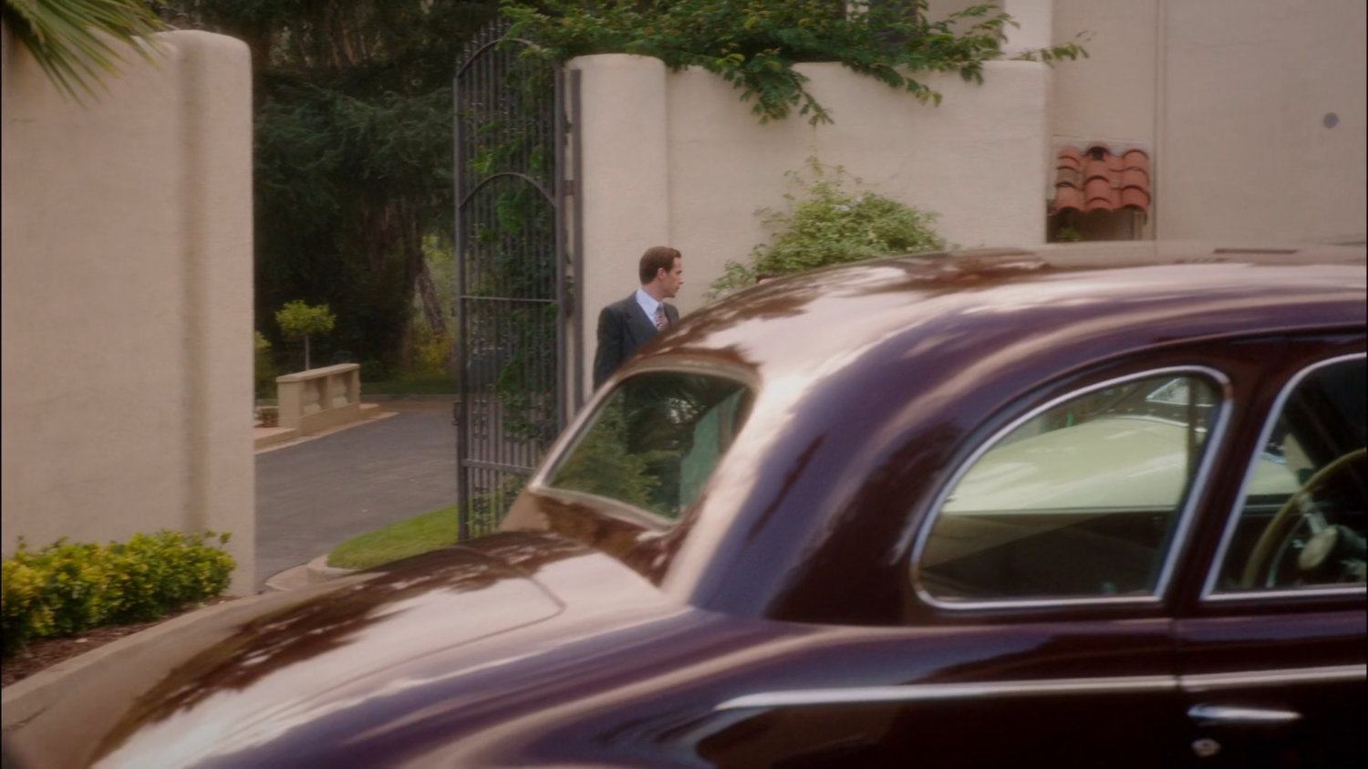 Jarvis outside Stark Mansion in driveway.