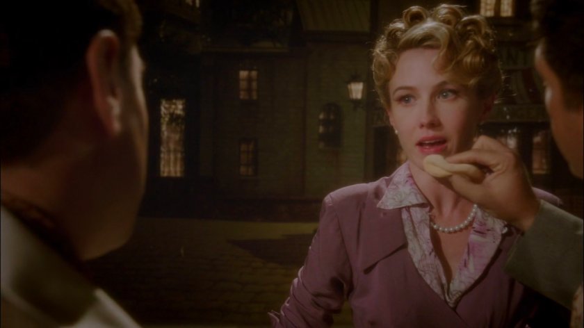 Whitney gets makeup applied while talking to Director on soundstage.