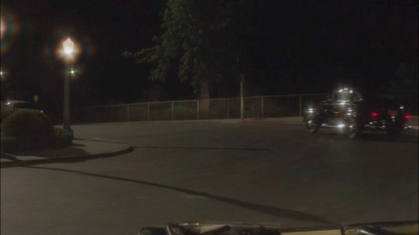 Cars driving away from Griffith Observatory at night.