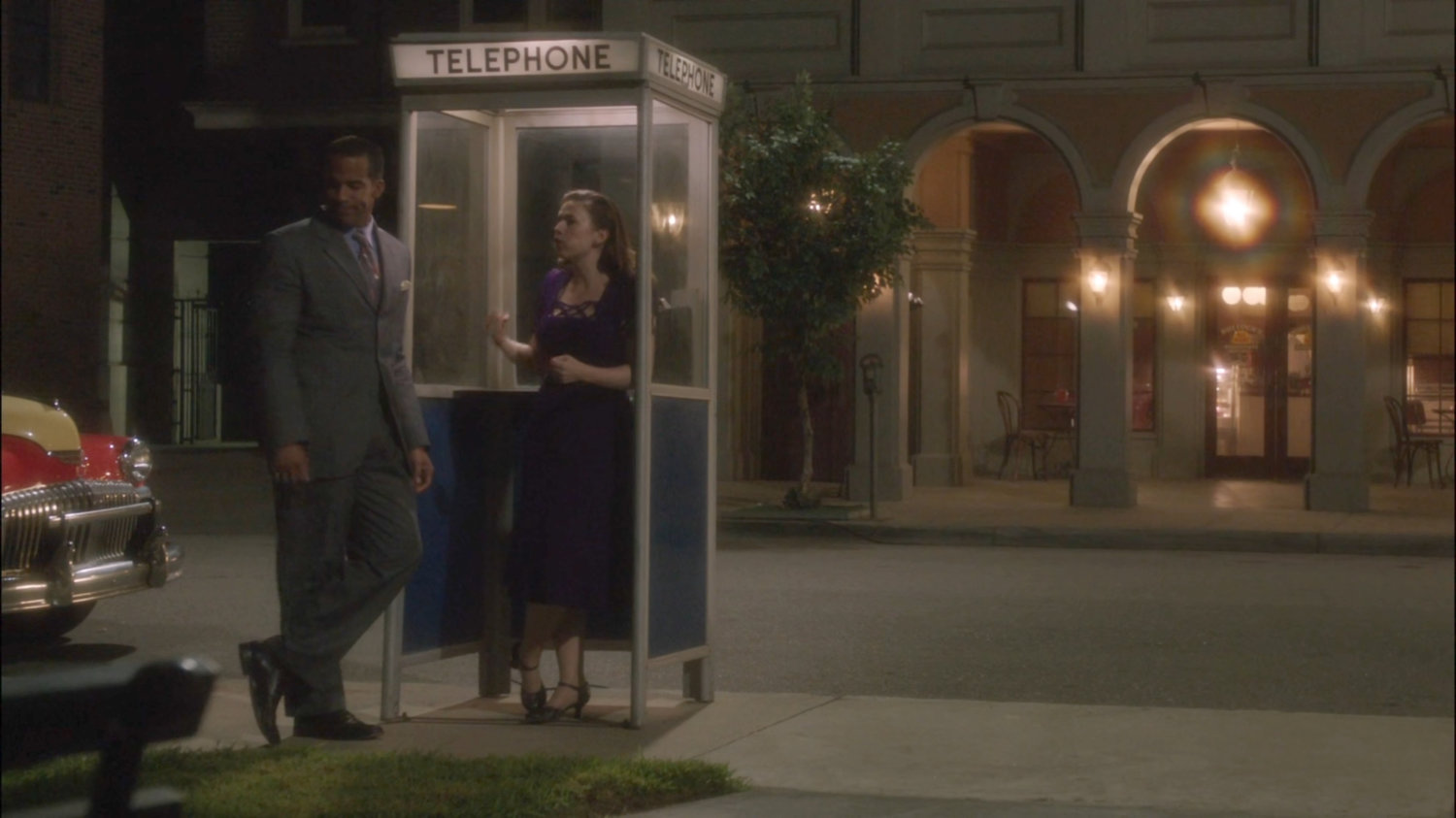 Peggy and Jason at phone booth outside Bullock's All Night Doughnuts.