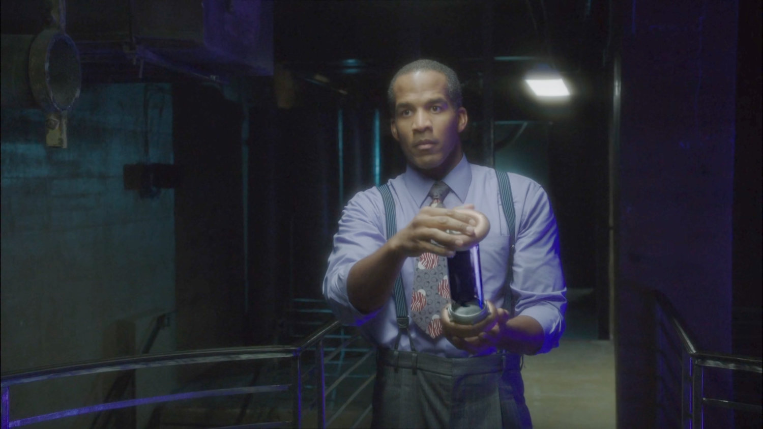 Jason Wilkes on a catwalk in Isodyne Energy holding Zero Matter tube.