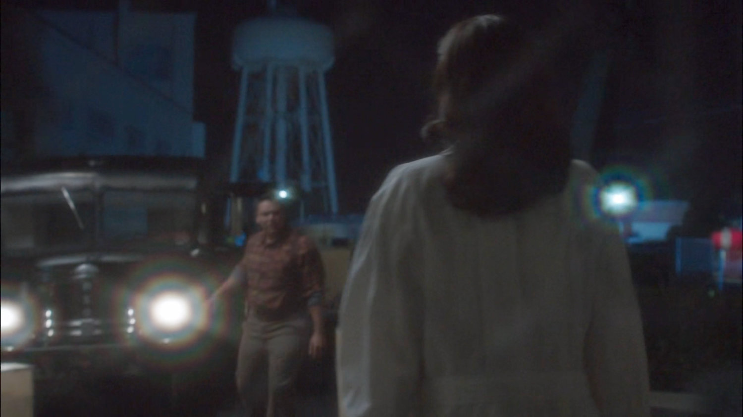 Peggy and thug at loading dock outside Isodyne Energy.