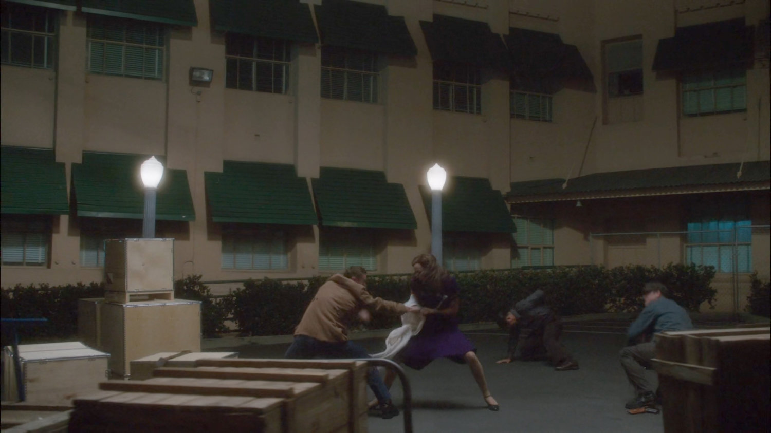 Peggy fighting thugs on loading dock outside Isodyne Energy.