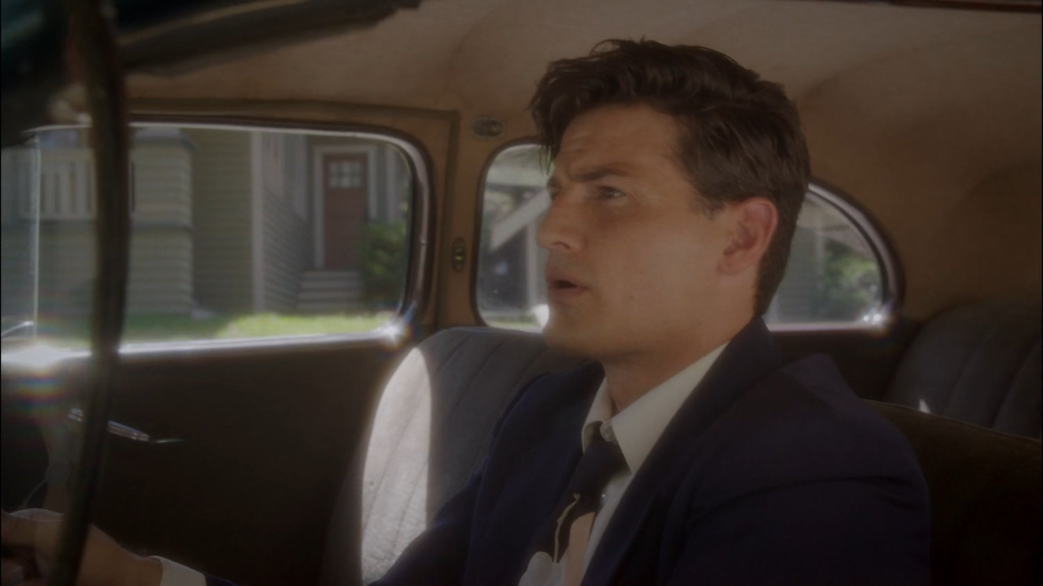 Sousa driving along the street outside his house.