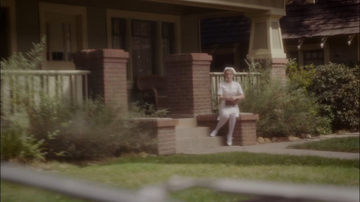 Violet sitting on front step of Sousa's House.