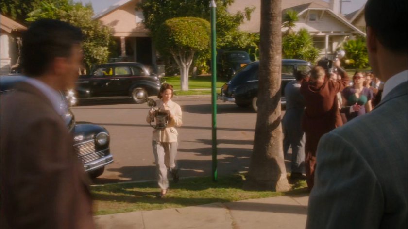 Cars, reporters, and police gather outside Jason Wilkes house.