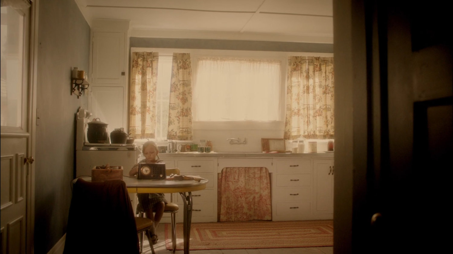 Young Agnes Cully in her kitchen working on a radio.