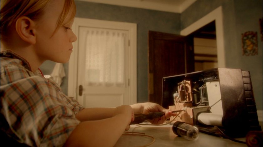 Young Agnes Cully in her kitchen working on a radio.
