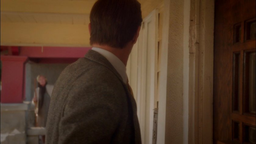 Jarvis looking at neighbor while standing at Rufus Hunt's front door.