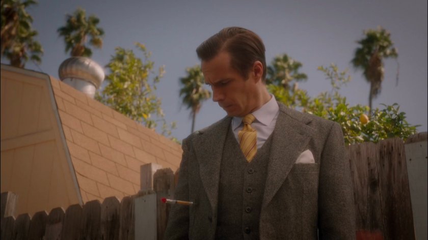 Jarvis standing in residential alley with dart stuck in his chest.