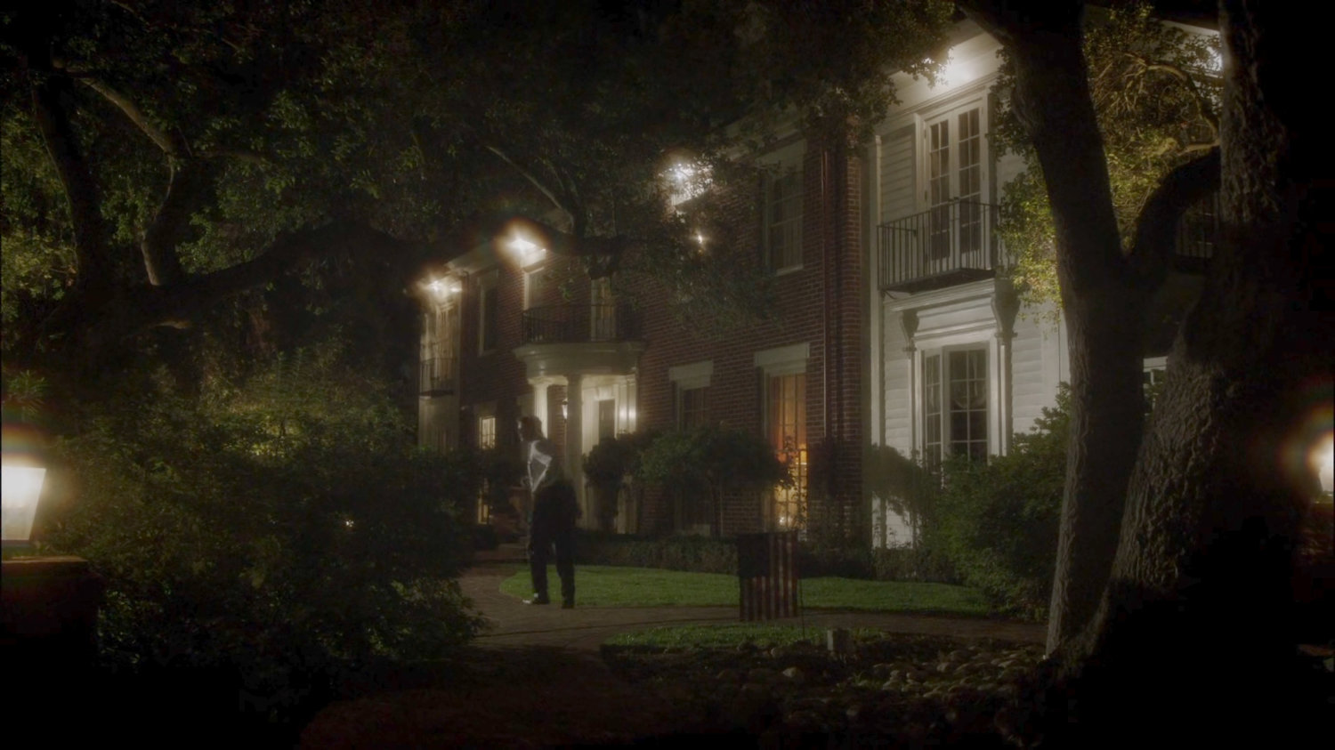 Rufus Hunt walking towards Calvin Chadwick house at night.