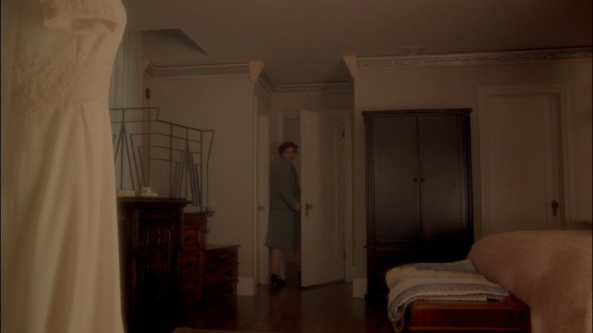 Peggy walking out of her room in her house.