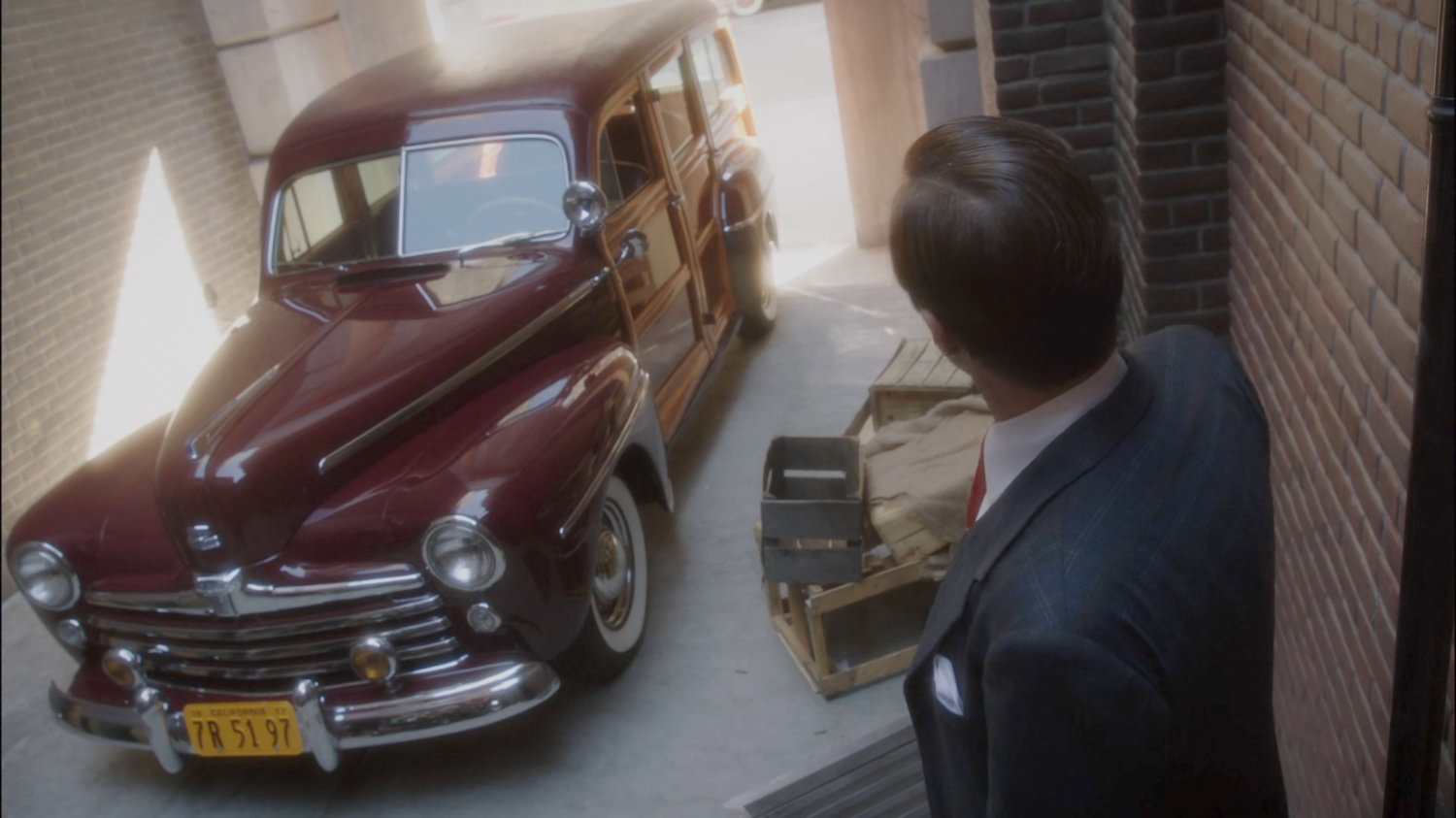 Jarvis looking at their car in the mouth of an alley outside County Cold Storage building.