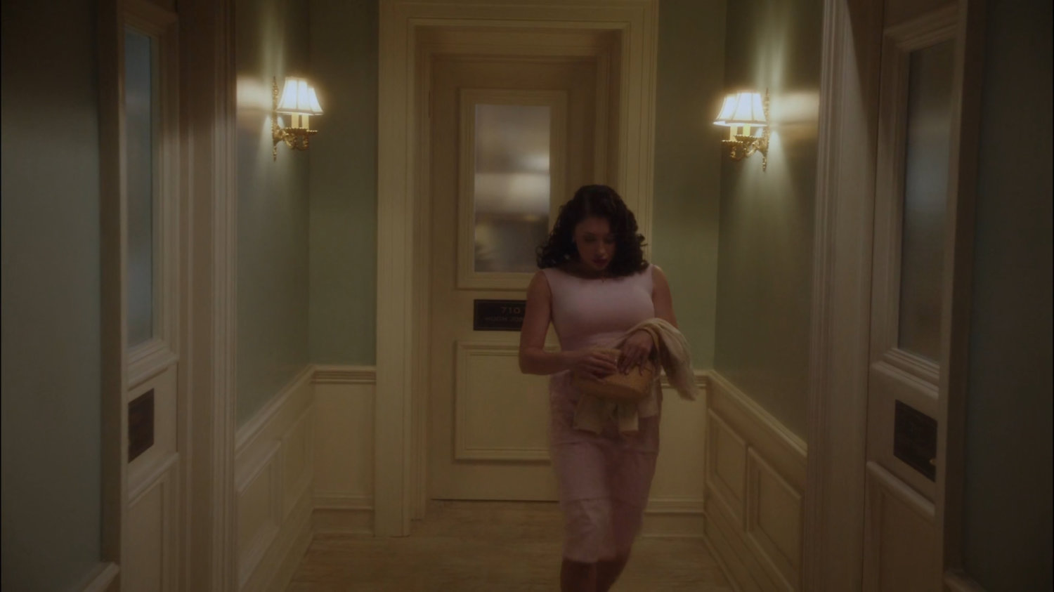 Roxxon secretary walking through hallway.