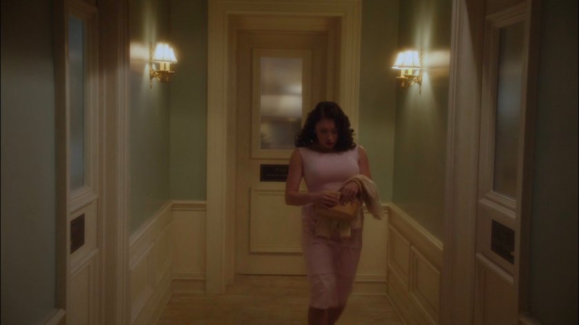 Roxxon secretary walking through hallway.