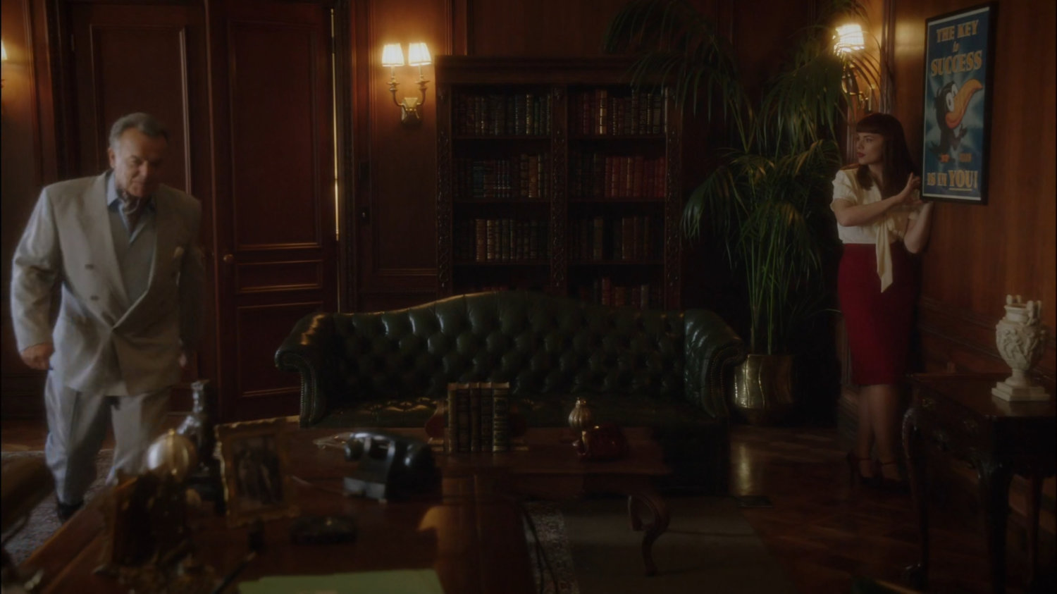 Peggy searching Hugh Jones offices as Hugh enters.
