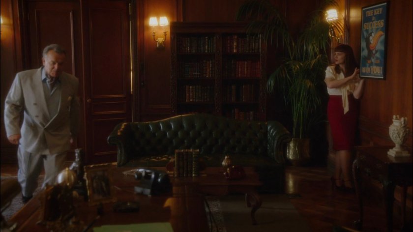 Peggy searching Hugh Jones offices as Hugh enters.