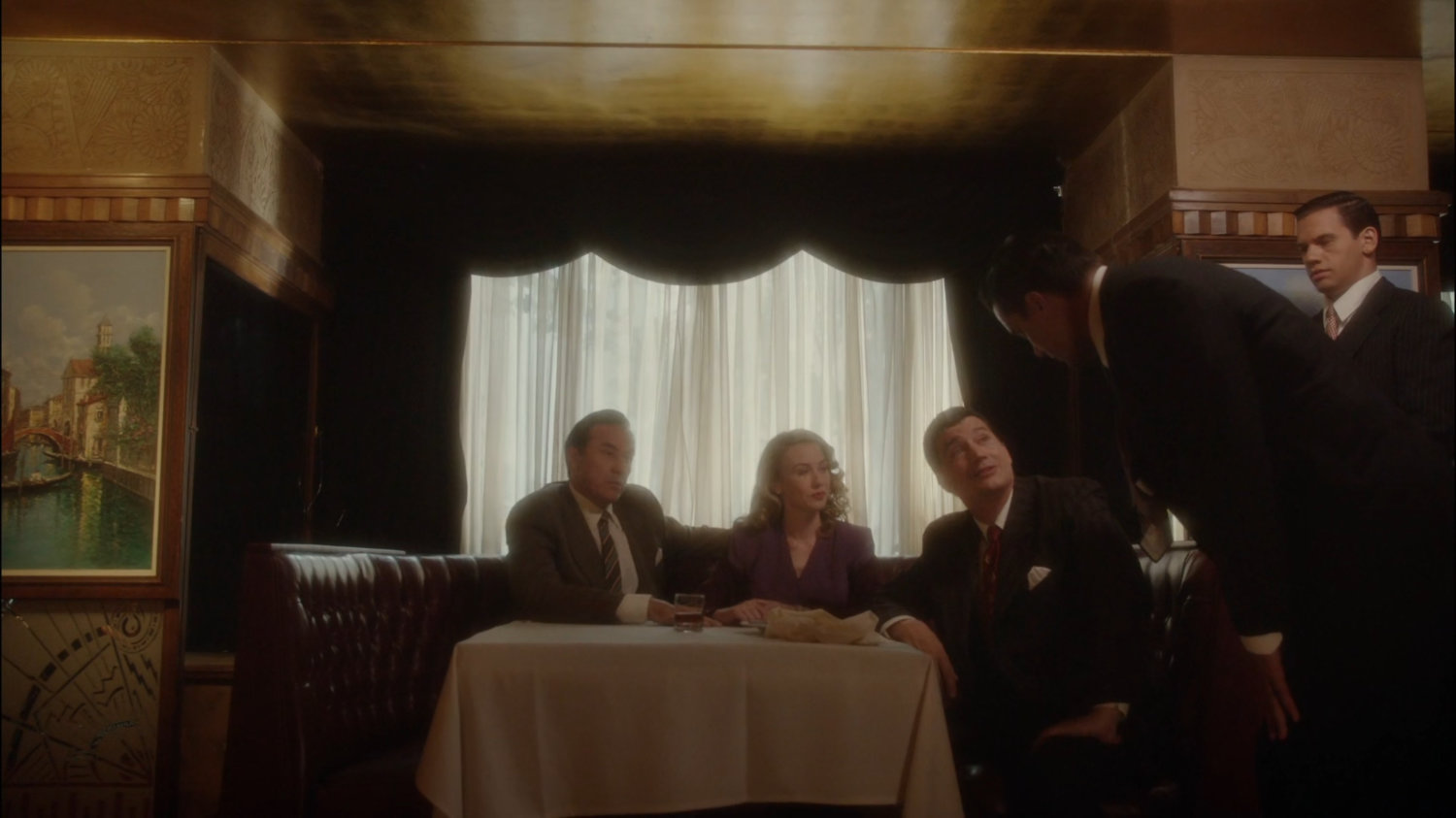 Calvin and Whitney speaking to Joseph Manfredi in a restaurant.