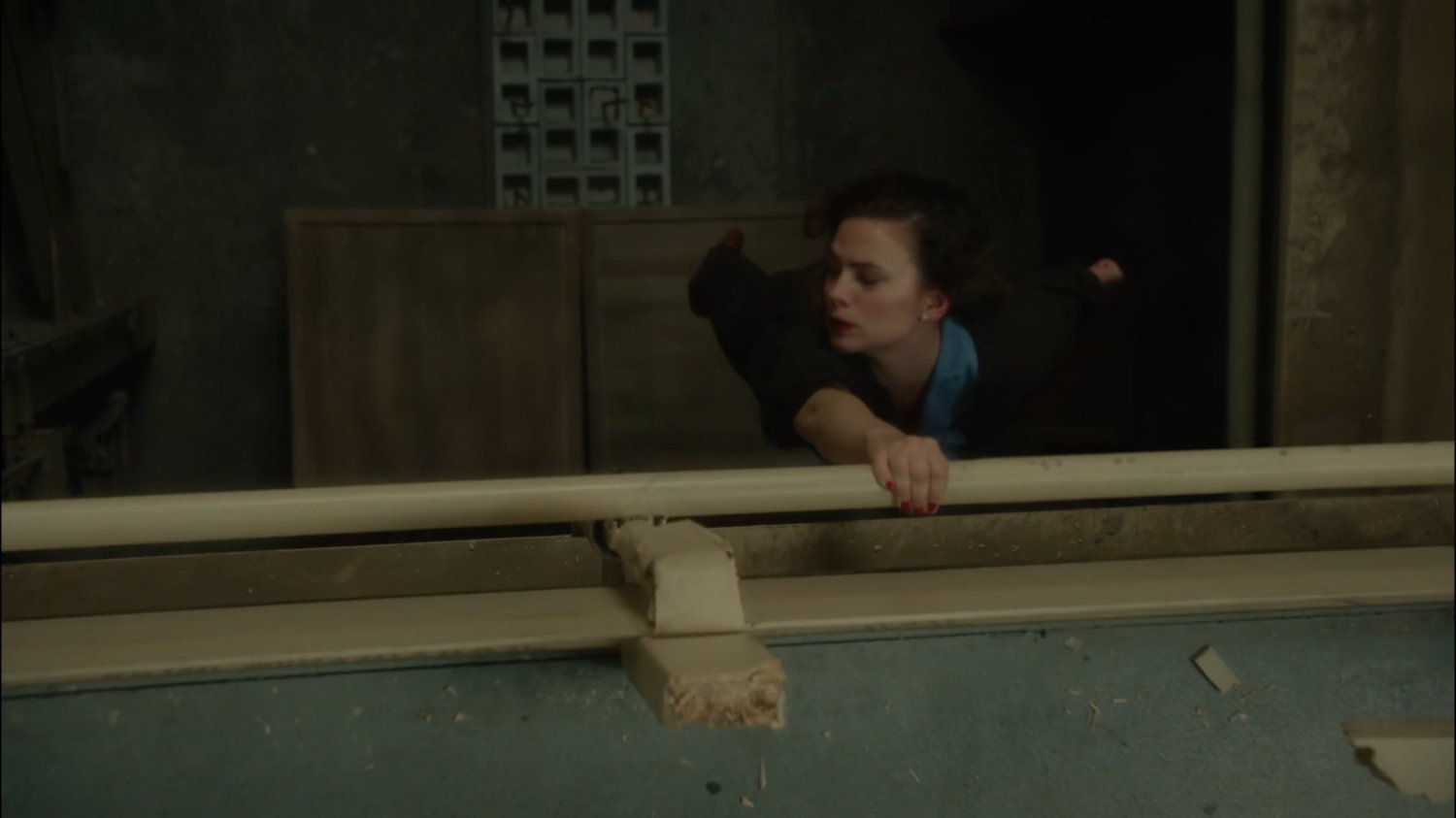 Peggy hanging off railing at the Roxxon warehouse.