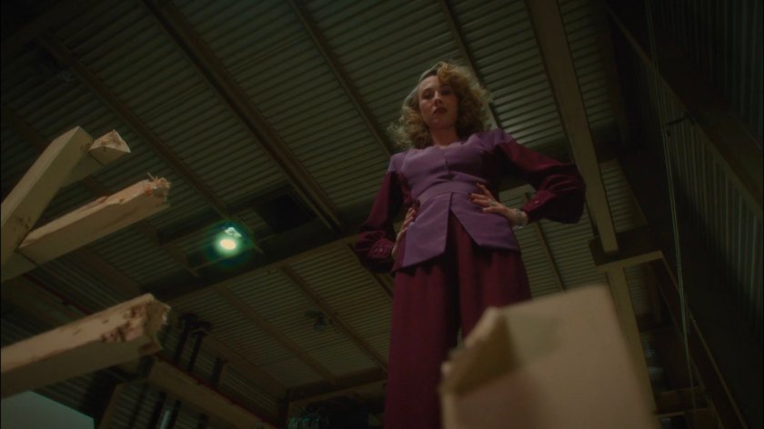 Whitney looking down at Peggy in Roxxon warehouse.