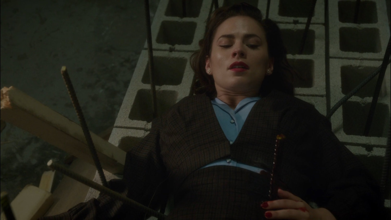 Peggy laying on cement blocks with rebar sticking through her side.