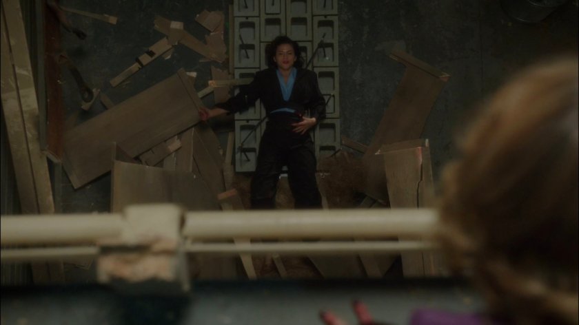 Whitney looking down on Peggy laying on cement blocks with rebar sticking through her side.