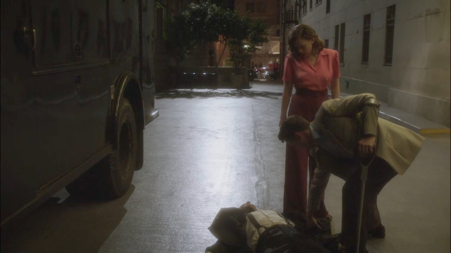 Sousa and Peggy checking a downed guard outside MacArthur Grand Hotel.
