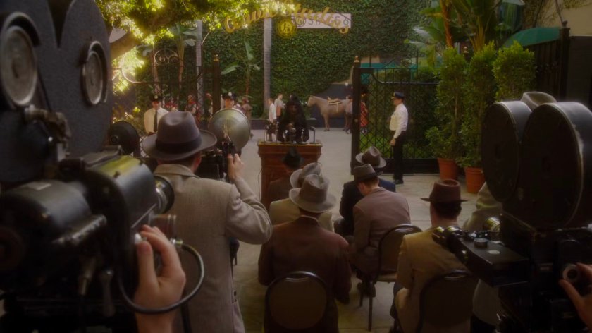 Whitney speaking at podium to audience gathered at front gate of Anvil Studios.