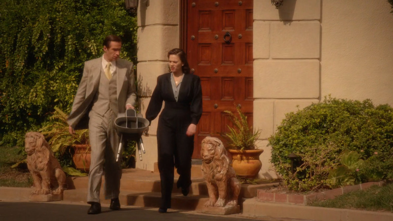 Jarvis and Peggy walking outside Stark Mansion.