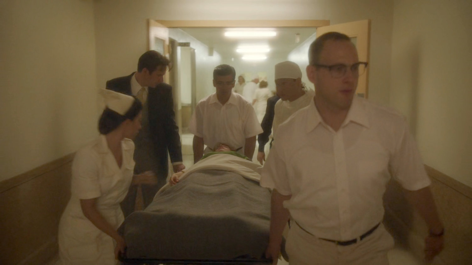 Jarvis walking with doctors and gurney inside Waverly Memorial Hospital.