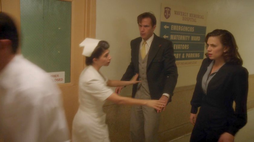 Nurse stopping Jarvis and Peggy from proceeding inside Waverly Memorial Hospital.