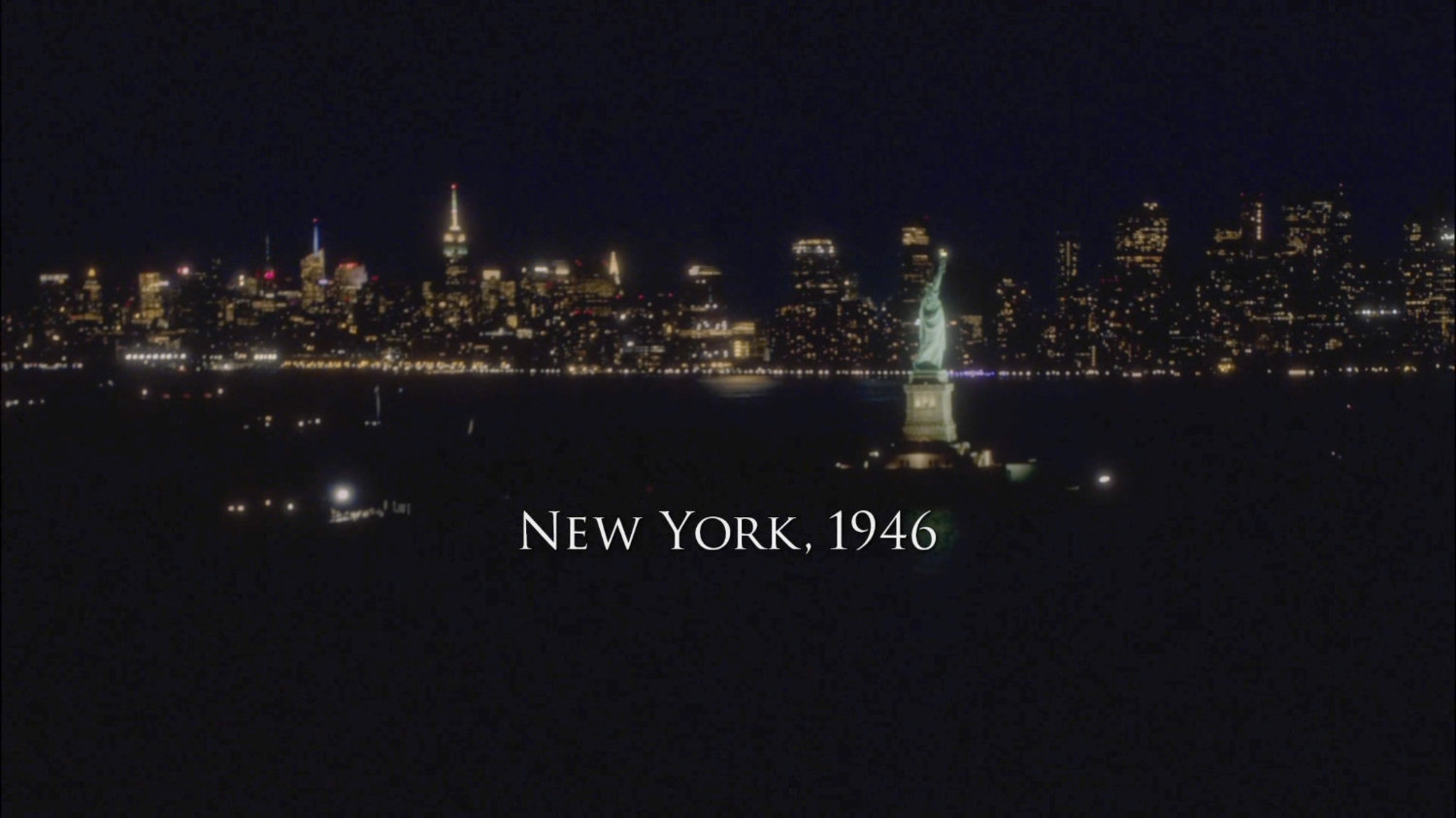 Aerial view of New York City and Statue of Liberty at night. text: New York City, 1946.