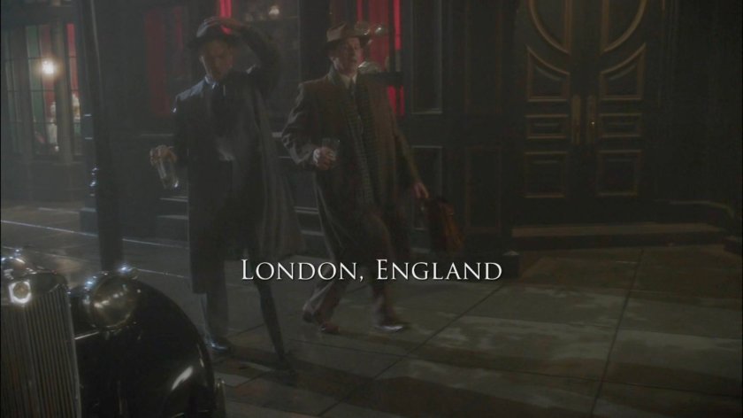 Thompson and Nick Driscoll cavorting drunkenly along sidewalk in London. Text: London, England.